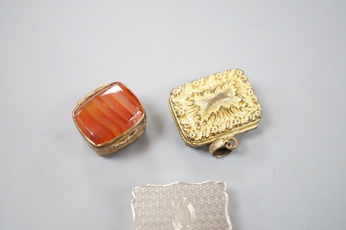 A Victorian engraved silver shaped rectangular vinaigrette, Alfred Taylor, Birmingham, 1850, 27mm and two other gilt metal vinaigrettes, one with inset agate lid.